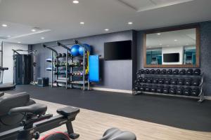 a fitness room with a gym with weights at Hampton Inn Towson Downtown in Towson