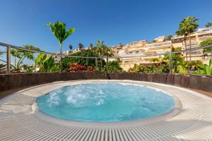 a large swimming pool in front of a building at Wyndham Residences Costa Adeje in Adeje