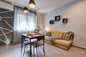 Casa RIGOLA by Apartments To Art في فيناريا ريالي: غرفة معيشة مع طاولة وأريكة