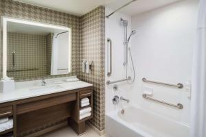 a bathroom with a sink and a tub and a shower at Home2 Suites By Hilton Towson in Towson