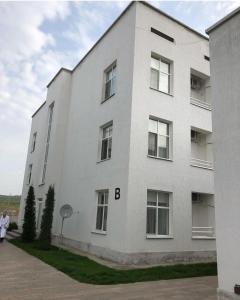a white building with the letter b on it at Keles Arasan SPA Hotel in Kökterek
