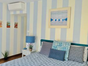 a bedroom with a bed with blue and white stripes at Luxury & Privacy - Pool, Parking, AC in Cannes