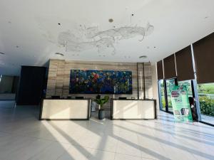 a lobby with two tables and a painting on the wall at The Arena Cam Ranh Beach Front in Cam Ranh