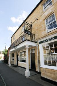 a building with a balcony on top of it at Fleur de Lys Bampton in Bampton