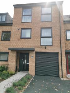 a brick house with a large garage door at Helena's Place (7 minutes walk to Nottingham Train station) in Nottingham