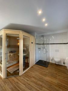 a bathroom with a shower and a toilet at Eifelsuiten - Suiten mit Sauna, Kamin und Balkon in der Vulkaneifel - Kerpen Loogh in Kerpen