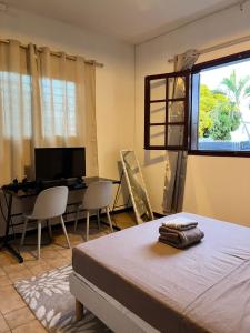 a bedroom with a bed and a desk and a window at NM-Housing in Saint-Denis