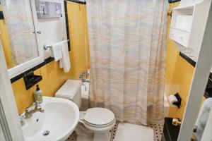 a bathroom with a toilet and a sink at Private 4 bed home in 1 acre lot - 10 mins to IAD airport in Herndon