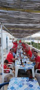 a group of people sitting at tables eating food at Paisagem do Guadiana Turismo Rural in Odeleite