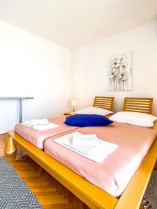 a large bed in a room with two beds at Zimmer - Room - Magdalena in Senj