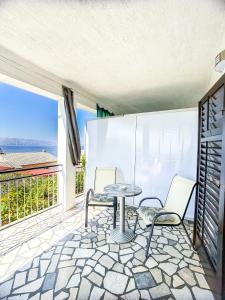 a patio with a table and chairs on a balcony at Zimmer - Room - Magdalena in Senj