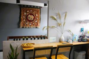 a kitchen with a wooden table with two chairs and a table sidx sidx at Lux Rooms Night Bazaar in Chiang Mai