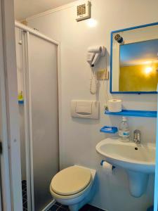 a bathroom with a toilet and a sink at B&B Colorado in Bergamo