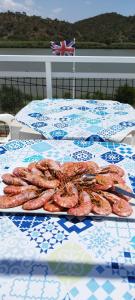 a table with a plate of food on top of it at Paisagem do Guadiana Turismo Rural in Odeleite