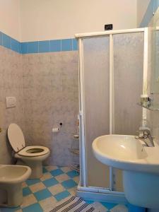 a bathroom with a toilet and a sink at B&B Colorado in Bergamo +10 photos