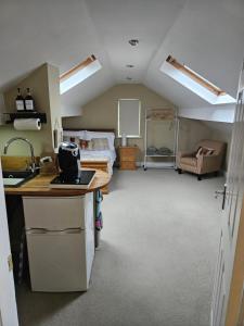 a bedroom with a bed and a desk in a room at The Attic in Dove Holes