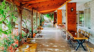 an empty patio with tables and chairs and plants at Karacan Park Hotel in Dalaman