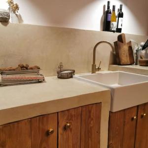 a kitchen with a sink and a counter with wine bottles at Chalet 1900, gîte de caractère 
