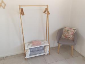 a room with a chair and a mirror and a pillow at GUESTHOUSE on REGENT Bed & Breakfast in Caloundra