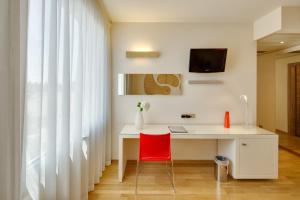 a bathroom with a sink, mirror and a television at Best Western Plus Leone di Messapia Hotel & Conference in Lecce