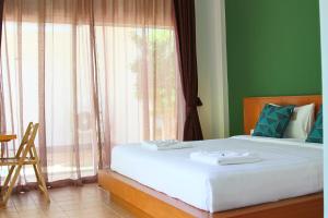 Voodi või voodid majutusasutuse Blue Palm Kata Resort toas