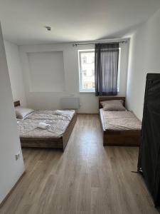 a room with two beds and a window at Dream Home in Szentes