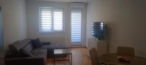 a living room with a couch and a tv at Ivan in Livno