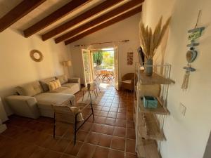 a living room with a couch and a table at Casa Turqueta-Son Xoriguer, Bungalow a 250m de la playa in Son Xoriguer