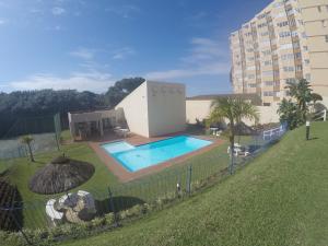 a building with a swimming pool next to a building at 65 Key Largo in Kingsburgh