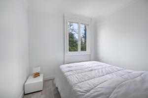 Maison avec jardin à 500m de la plage, Pornic في بورنيك: غرفة نوم بيضاء بها سرير ونافذة