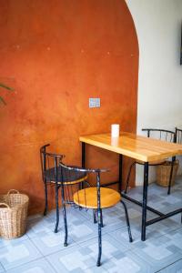 a table and two chairs and a table and a table at The Real Place Hostel in Battambang