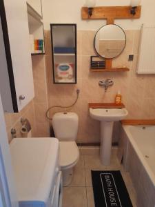 a bathroom with a white toilet and a sink at Mieszkanie Warszawska 5 in Giżycko