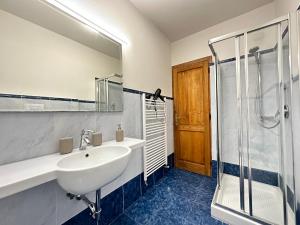a bathroom with a sink and a shower at Luxurious View on Santa Croce in Florence