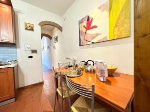 a kitchen with a table and chairs in a room at Luxurious View on Santa Croce in Florence