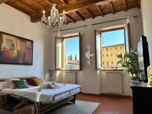 a bedroom with a bed in a room with windows at Luxurious View on Santa Croce in Florence