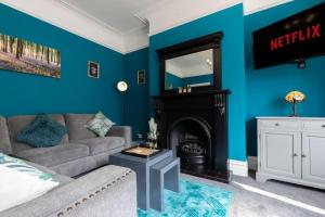 a living room with a couch and a fireplace at Big House, and a lot to give! in Middlesbrough