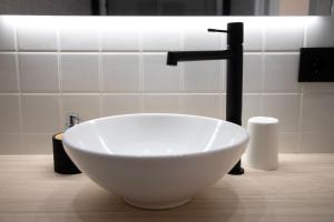 a bathroom with a white bowl sink and a faucet at Ponteloft - Curriño in Pontevedra