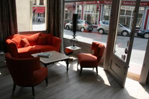 a living room with a couch and two chairs and a table at La Maison Normande in Trouville-sur-Mer