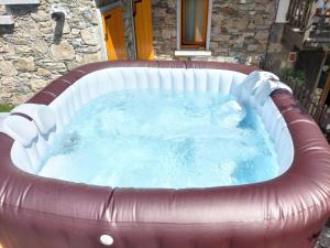 a large hot tub in a red and white at Bella Italia chalet in Massino Visconti