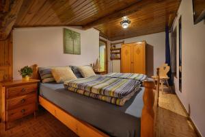 a bedroom with a bed and a wooden ceiling at Appartamenti Astra in Livigno