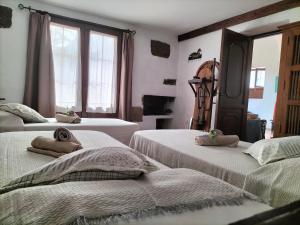 a bedroom with three beds with towels on them at Casa Rural "La Molina" in Máguez