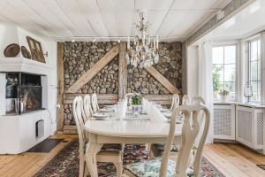 a dining room with a white table and chairs at Stubbegården - Unique swedish style in Vadstena