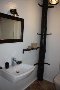 a bathroom with a sink and a mirror on the wall at Casa Rural "La Molina" in Máguez