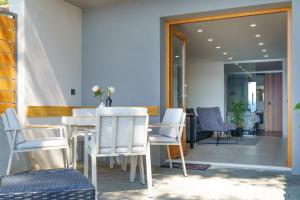 a dining room with white chairs and a table at Apartments Bikin in Brela