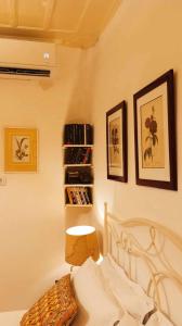 a bedroom with a bed and pictures on the wall at CORALLI in Spetses
