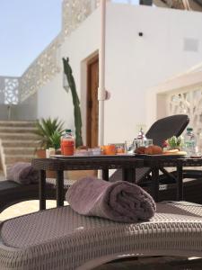 a table with a towel sitting on a patio at Riad El Pacha in Rabat +49 photos