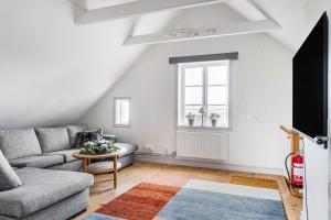 a living room with a couch and a window at STUBBET - Charming - Newly Remade Villa in Vadstena