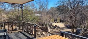 a porch with stairs and a view of a zoo at River Rock Lodge in Parys