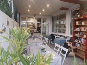 a woman sitting at a table in a restaurant at Dream House in Tsarevo