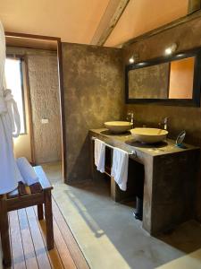 a bathroom with two sinks and a mirror at Windhoek Game Camp in Lafrenz Township